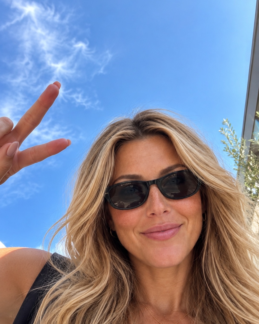 The same AI woman outside on a sunny day